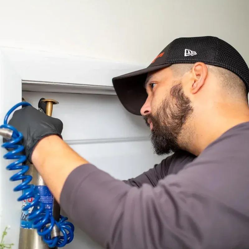 Florida Termite Guys technician applying professional termite treatment at Miami Beach property