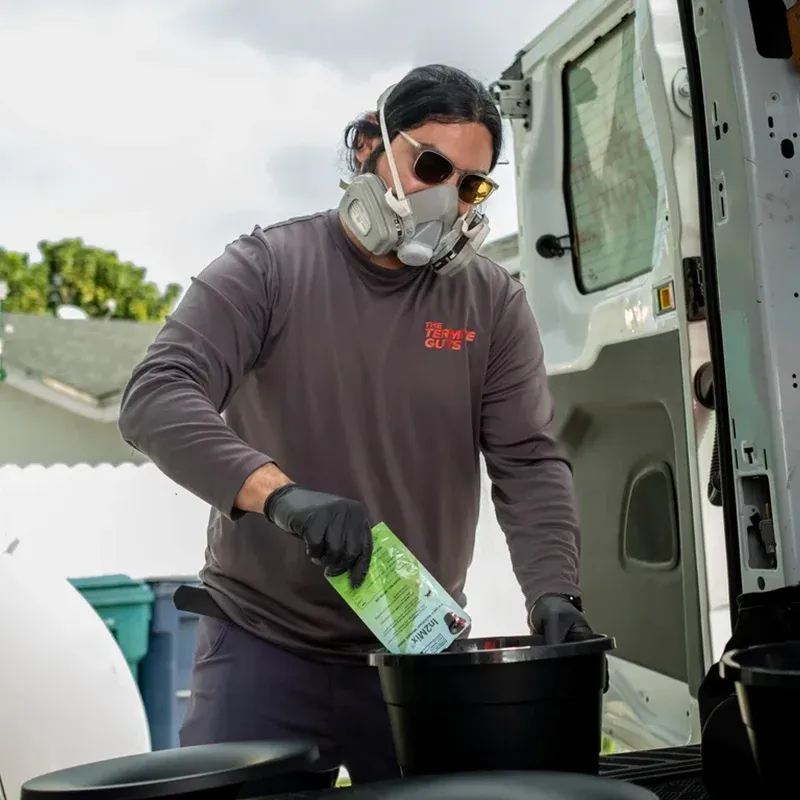 Florida Termite Guys technician performing termite control treatment at Coral Gables residence