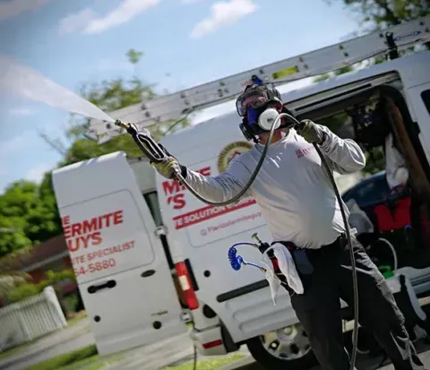Technician applying tentless termite treatment at Coral Gables home